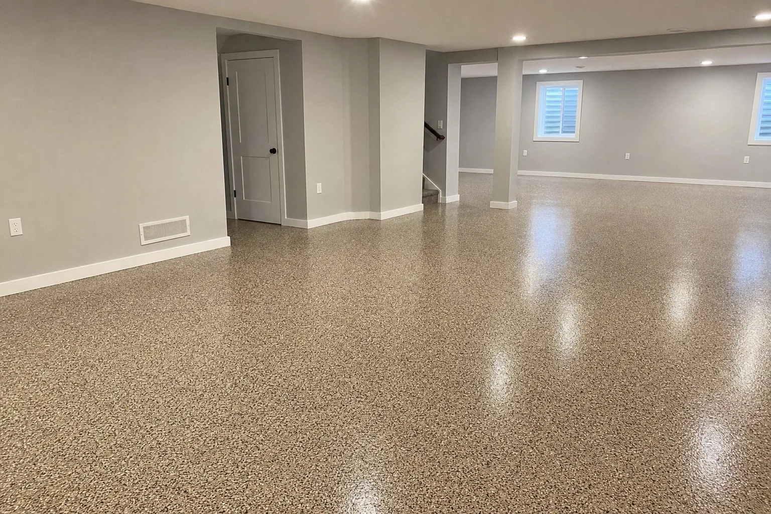 Finished basement with a tan decorative flake epoxy floor